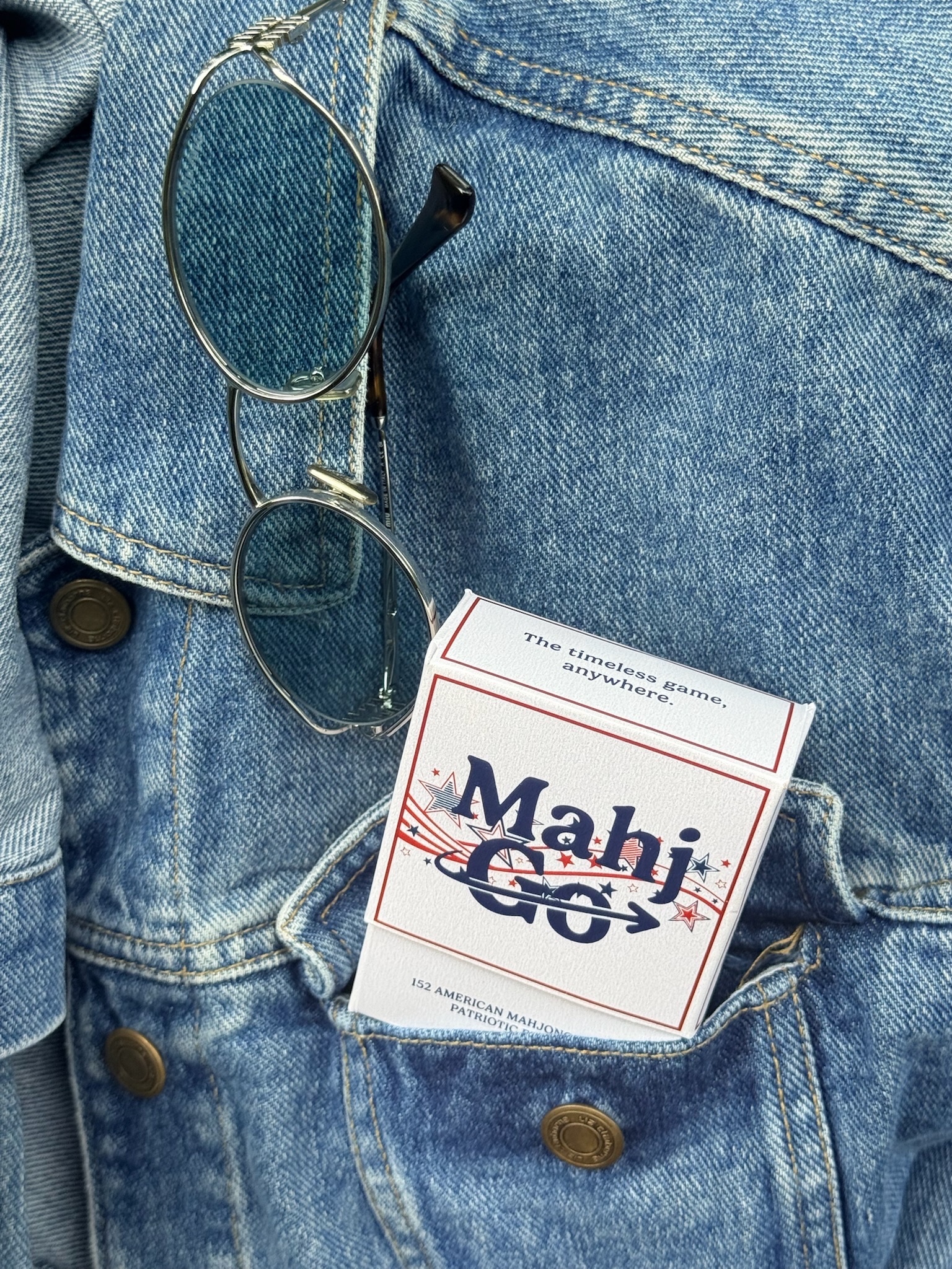 Patriotic MahjGo mahjong playing cards in a jean jacket pocket